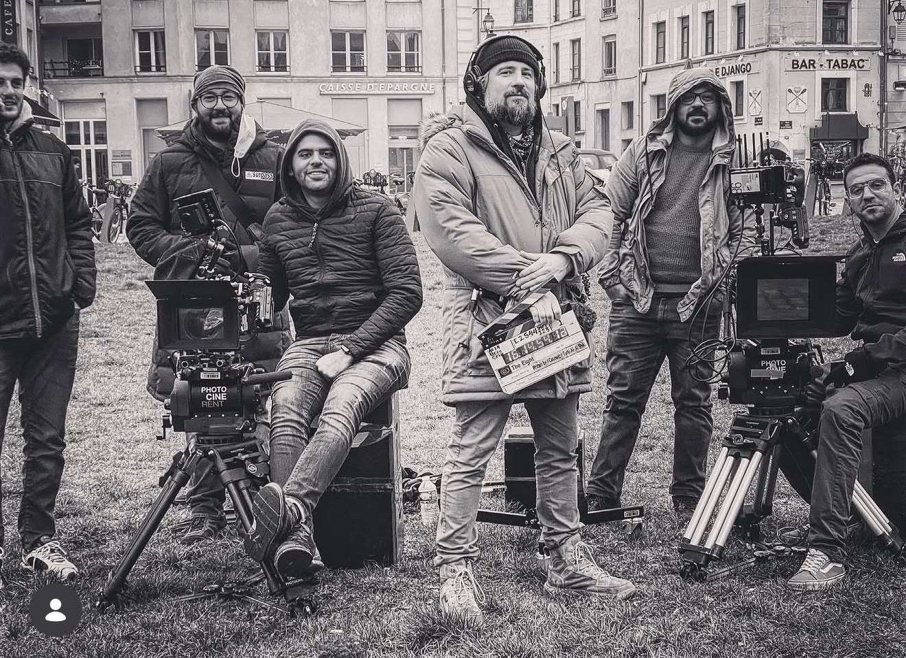 Joseph Watson holding a slate with his camera crew on location in France