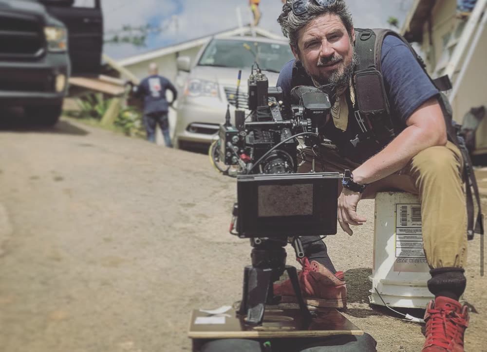 Cinema camera set low on location with its operator