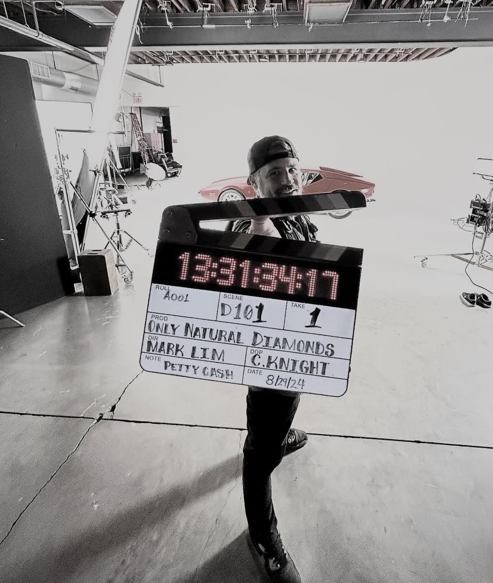 Holding a slate on a white studio stage
